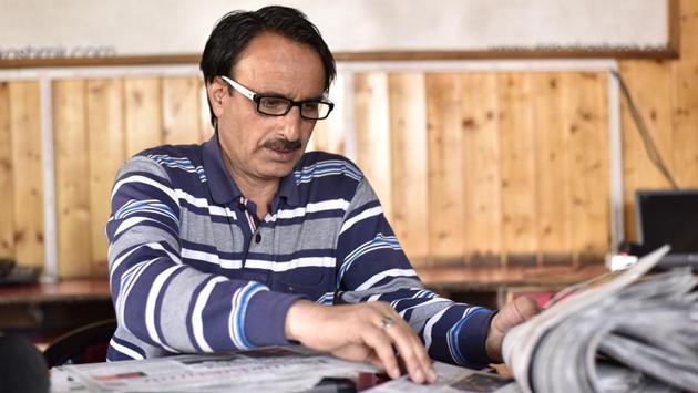Farooq Javed Khan, president of the Kashmir Press Photographers Association flips through a newspaper at Rising Kashmir’s office in Srinagar. “Questions are constantly thrown at us about our work. For a newspaper photo, in case of a death, we try not to show the body so people say, ‘you never show the body because you don’t want to show,” Khan said. (Ajay Aggarwal / HT Photo) Farooq Javed Khan, president of the Kashmir Press Photographers Association flips through a newspaper at Rising Kashmir’s office in Srinagar. “Questions are constantly thrown at us about our work. For a newspaper photo, in case of a death, we try not to show the body so people say, ‘you never show the body because you don’t want to show,” Khan said. (Ajay Aggarwal / HT Photo)