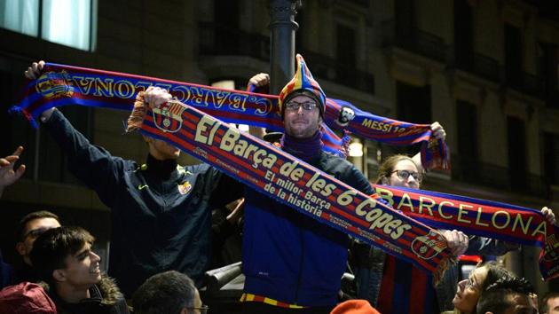 FC Barcelona football fans celebrate in Barcelona after the club claimed its 25th La Liga title following a thrilling 4-2 victory at Deportivo La Coruna on Sunday. (AFP) FC Barcelona football fans celebrate in Barcelona after the club claimed its 25th La Liga title following a thrilling 4-2 victory at Deportivo La Coruna on Sunday. (AFP)