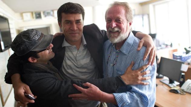 Agence France-Presse (AFP) photographer Shah Marai (C) embraces colleagues Massoud Hossaini (L) and Lawrence Bartlett (R), after Hossain had won the Pulitzer Prize, at the AFP office in Kabul on April 17, 2012. The 22-year veteran of the agency leaves behind two wives and six children. (Johannes Eisele / AFP) Agence France-Presse (AFP) photographer Shah Marai (C) embraces colleagues Massoud Hossaini (L) and Lawrence Bartlett (R), after Hossain had won the Pulitzer Prize, at the AFP office in Kabul on April 17, 2012. The 22-year veteran of the agency leaves behind two wives and six children. (Johannes Eisele / AFP)