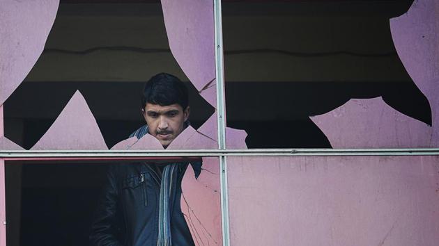 An Afghan resident looks through a broken window at the site of a suicide attack in Kabul on January 26, 2014. Marai often spoke candidly of sleepless nights haunted by what he had seen and endured, and of his fears as Kabul slipped further into violence. (Shah Marai / AFP File) An Afghan resident looks through a broken window at the site of a suicide attack in Kabul on January 26, 2014. Marai often spoke candidly of sleepless nights haunted by what he had seen and endured, and of his fears as Kabul slipped further into violence. (Shah Marai / AFP File)