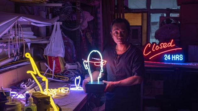 Neon sign maker Wu Chi-kai is one of the last craftsmen of his kind in Hong Kong, a city where darkness never falls thanks to the 24-hour glow of a myriad lights. During his 30 years in the business, neon came to define the urban landscape, advertising everything from restaurants to mahjong parlours. But with the growing popularity of LED lights, demand for specialists like Chi-kai has dimmed. (Philip Fong / AFP)