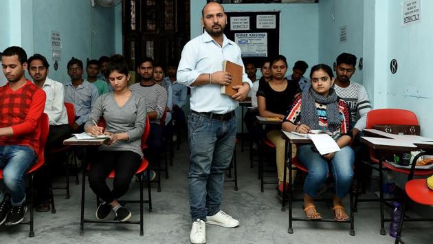 Surbir Singh, 35, is a shorthand teacher seen here at a stenography centre surrounded by students in Faridabad, India. Shorthand, the nearly two centuries old note taking system was once an essential skill to landing any government job or one in courts and businesses as stenographers. Today, with computers, recorders and apps the skill finds far fewer takers. (Money Sharma / AFP)