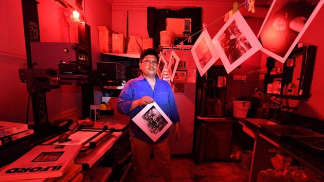 Vicky Luthra, an expert photograph developer and printer, poses with a black and white print in the darkroom at his SV Photographic printing studios in New Delhi, India. In times of digital cameras and platforms to publish images instantly, Luthra caters to photographers still patient enough to wait for a an image’s journey from film to photographic print before the final reveal. (Prakash Singh / AFP)