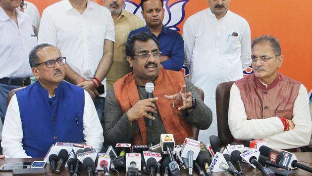 Bharatiya Janata Party (BJP) national spokesperson Ram Madhav, flanked by Nirmal Singh and Kavinder Gupta, addresses a press conference on the cabinet reshuffle, in Jammu on Monday.(PTI)