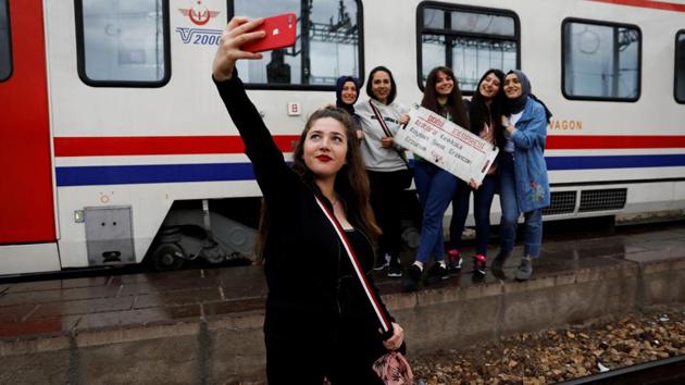 As the references on social media to the train journey proliferated, must-do rituals emerged for all travellers. It’s now customary to take snaps holding the signs in the carriages showing the route. (Umit Bektas / REUTERS) As the references on social media to the train journey proliferated, must-do rituals emerged for all travellers. It’s now customary to take snaps holding the signs in the carriages showing the route. (Umit Bektas / REUTERS)