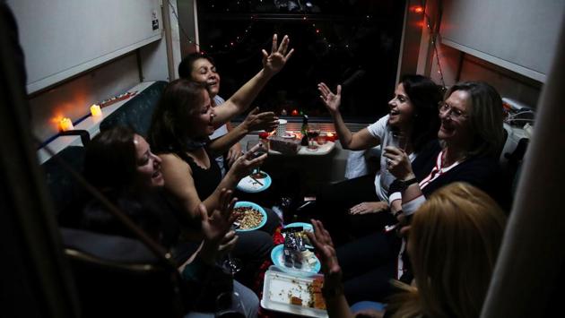 Passengers listen to music on board the Eastern Express travelling through Sivas province. Tourists decorate compartment with Christmas lights, candles and balloons, holding big parties in spaces designed for four only, taking group photos. (Umit Bektas / REUTERS) Passengers listen to music on board the Eastern Express travelling through Sivas province. Tourists decorate compartment with Christmas lights, candles and balloons, holding big parties in spaces designed for four only, taking group photos. (Umit Bektas / REUTERS)