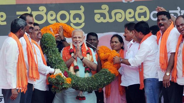 Prime Minister Narendra Modi being garlanded by BJP workers at an election campaign rally ahead of the Karnataka polls, in Udupi on Tuesday. (PTI) Prime Minister Narendra Modi being garlanded by BJP workers at an election campaign rally ahead of the Karnataka polls, in Udupi on Tuesday. (PTI)