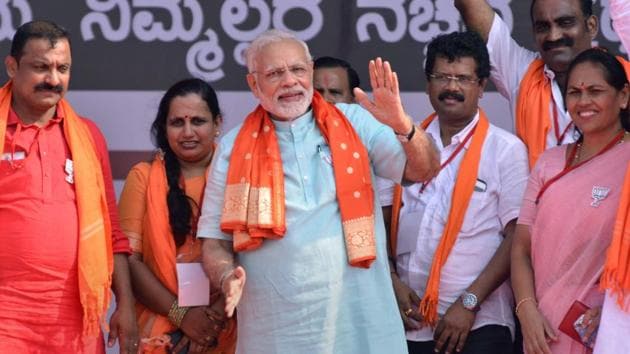 Prime Minister Narendra Modi with BJP workers at an election campaign rally in Karnataka’s Udupi on Tuesday.(PTI)