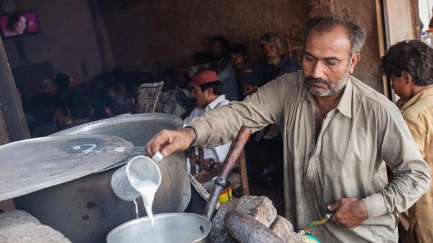 In a small tea shop in Sujawal, Imam Dino has hit upon a profitable idea. A 24-inch television plays Bollywood movies through the day and customers get phone charging sockets in a town that otherwise suffers long outages. All this from a solar-panel system he rents for 2,500 rupees ($22) a month. (Asim Hafeez / Bloomberg) In a small tea shop in Sujawal, Imam Dino has hit upon a profitable idea. A 24-inch television plays Bollywood movies through the day and customers get phone charging sockets in a town that otherwise suffers long outages. All this from a solar-panel system he rents for 2,500 rupees ($22) a month. (Asim Hafeez / Bloomberg)
