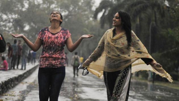 Girls in a jubilant mood during rain at the Sukhna Lake in Chandigarh on Wednesday afternoon. (Karun Sharma/ht)