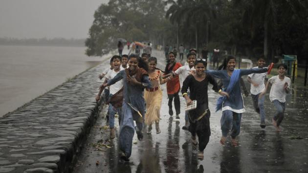 Kids enjoying the rain at the Sukhna Lake after days of heat waves in Chandigarh on Wednesday. (Karun sharma/ht)
