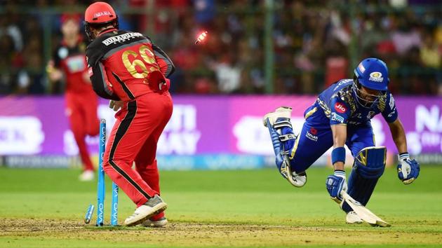 Royal Challengers Bangalore (RCB) wicketkeeper Quinton De Kock runs out of Mumbai Indians’ J P Duminy during the IPL 2018 match at Chinnaswamy Stadium in Bengaluru on Tuesday. (PTI) Royal Challengers Bangalore (RCB) wicketkeeper Quinton De Kock runs out of Mumbai Indians’ J P Duminy during the IPL 2018 match at Chinnaswamy Stadium in Bengaluru on Tuesday. (PTI)