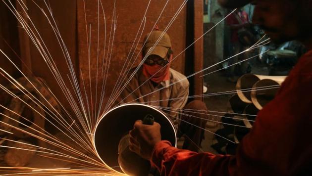 A worker cuts metal inside a workshop manufacturing metal pipes in Mumbai, India. (Reuters File Photo) A worker cuts metal inside a workshop manufacturing metal pipes in Mumbai, India. (Reuters File Photo)