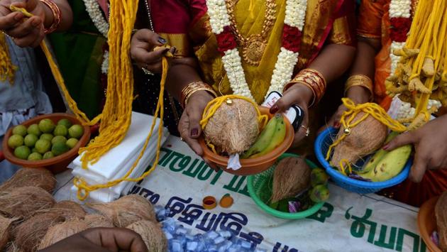 The brides purchase ‘thali’ or yellow threads that will be tied around their necks during the marriage ritual. The festival and its participants re-enact Aravan and Mohini’s marriage from the Mahabharata. (Arun Sankar / AFP)