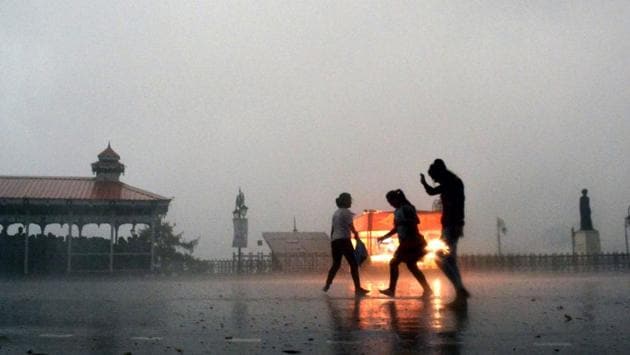 People run for cover during storm and rain on The Ridge in Shimla on Wednesday afternoon. (Deepak Sansta/ht)