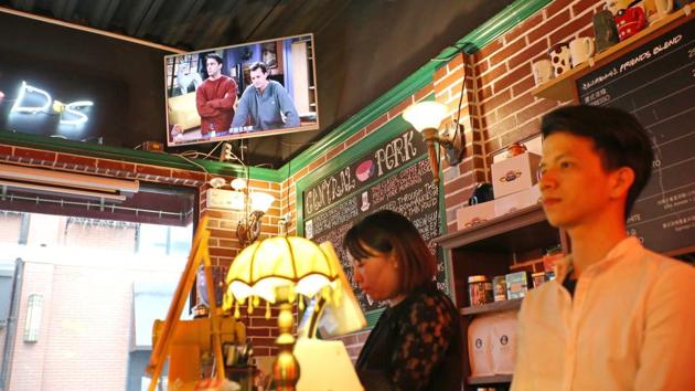 Staff members stand behind a counter as a television plays the US sitcom Friends at the “Central Perk” coffee shop in Shanghai. Millions of Chinese Friends fans are heartbroken after a video site pulled the show, beloved by millennials in China for its endearing young characters and as an English conversation resource. (AFP) Staff members stand behind a counter as a television plays the US sitcom Friends at the “Central Perk” coffee shop in Shanghai. Millions of Chinese Friends fans are heartbroken after a video site pulled the show, beloved by millennials in China for its endearing young characters and as an English conversation resource. (AFP)