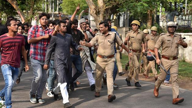 Police tries control the situation after a clash between two groups at Aligarh Muslim University on Wednesday.(PTI Photo)