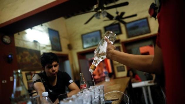 A resident watches as the bartender pours tequila for a traditional drink called a ‘Batanga’ at La Capilla bar in Tequila, Jalisco. “This is my life and I am very proud of it. I know how to do it well. I hope technology does not replace us, it will be devastating,” said Francisco Quiroz, a 57-year-old jimador. (Carlos Jasso / REUTERS) A resident watches as the bartender pours tequila for a traditional drink called a ‘Batanga’ at La Capilla bar in Tequila, Jalisco. “This is my life and I am very proud of it. I know how to do it well. I hope technology does not replace us, it will be devastating,” said Francisco Quiroz, a 57-year-old jimador. (Carlos Jasso / REUTERS)