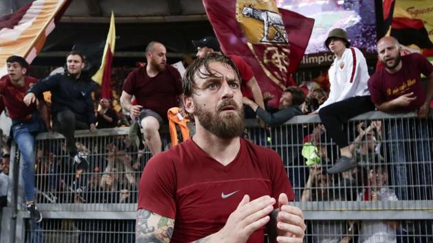 AS Roma's Italian midfielder Daniele De Rossi acknowledges fans at the end of the match against Liverpool FC. (AFP) AS Roma's Italian midfielder Daniele De Rossi acknowledges fans at the end of the match against Liverpool FC. (AFP)