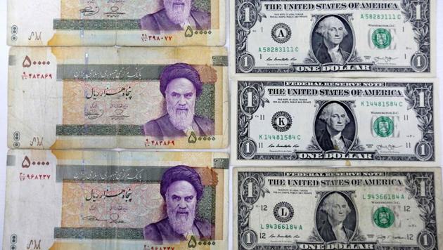 A close up shot shows Iran's various Rial banknotes, bearing a portrait of Iran's late founder of Islamic Republic Ayatollah Ruhollah Khomeini, next to United States one-Dollar bills bearing a portrait of first US President, George Washington at a currency exchange office in a shopping centre in the capital Tehran on April 10. (AFP File Photo) A close up shot shows Iran's various Rial banknotes, bearing a portrait of Iran's late founder of Islamic Republic Ayatollah Ruhollah Khomeini, next to United States one-Dollar bills bearing a portrait of first US President, George Washington at a currency exchange office in a shopping centre in the capital Tehran on April 10. (AFP File Photo)