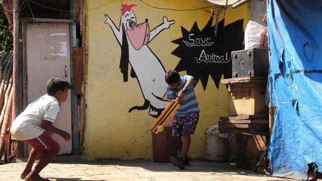 Children playing cricket in the backdrop of painted wall . (Bhushan Koyande/HT PHOTO) Children playing cricket in the backdrop of painted wall . (Bhushan Koyande/HT PHOTO)