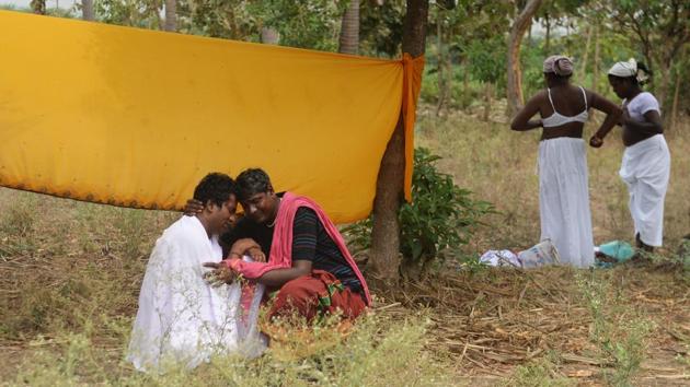 Transgender devotees embrace as others dress up in white saris during the annual festival of the Hindu god Aravan in Tamil Nadu’s Koovagam village. Members of the transgender community and devotees from all over India gather at the Koothandavar Temple each year during the full moon of the Tamil month of Chitrai, to participate in the re-enactment of a tale from the Indian epic, the Mahabharata. (Arun Sankar / AFP)