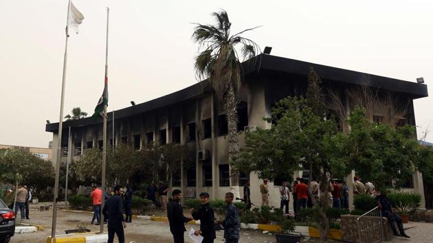 Libyan policemen check the damage at the Libyan electoral commission headquarters in the capital, Tripoli, after it was targeted by suicide bombers on May 2, 2018. (AFP) Libyan policemen check the damage at the Libyan electoral commission headquarters in the capital, Tripoli, after it was targeted by suicide bombers on May 2, 2018. (AFP)