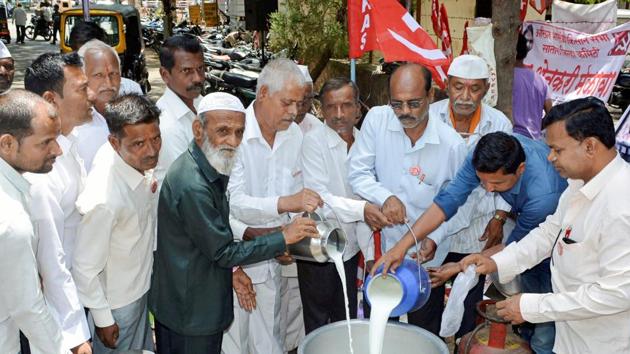 Kisan Sabha activists with farmers distribute milk free of cost to protest the low procurement prices by dairies in the state, in Karad, Maharashtra, on Thursday.(PTI photo)