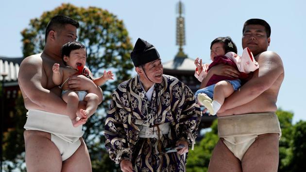 Nine-month-old Kizuki (L) and 10-month-old Sarah, cry as they are held up by amateur sumo wrestlers while a referee makes faces and loud noises during a baby crying contest at Sensoji temple in Tokyo, Japan. (Issei Kato / REUTERS) Nine-month-old Kizuki (L) and 10-month-old Sarah, cry as they are held up by amateur sumo wrestlers while a referee makes faces and loud noises during a baby crying contest at Sensoji temple in Tokyo, Japan. (Issei Kato / REUTERS)