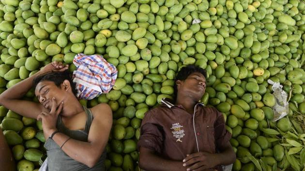 Labourers rest after unloading mangoes at the Gaddiannaram fruit market on the outskirts of Hyderabad, Telangana on April 30, 2018. (Noah Seelam / AFP) Labourers rest after unloading mangoes at the Gaddiannaram fruit market on the outskirts of Hyderabad, Telangana on April 30, 2018. (Noah Seelam / AFP)