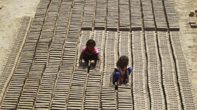 Children work at a brick factory on the outskirts of Jammu city in Jammu and Kashmir on May 1, 2018. International Labour Day also known as May Day was marked across the world on May 1. (Channi Anand / AP) Children work at a brick factory on the outskirts of Jammu city in Jammu and Kashmir on May 1, 2018. International Labour Day also known as May Day was marked across the world on May 1. (Channi Anand / AP)