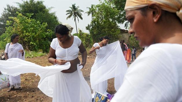 Transgender devotees dress up in white saris after a ritual signifying their marriage to the Hindu warrior god Aravan at the Koothandavar temple in Tamil Nadu’s Koovagam village on May 2, 2018. (Arun Sankar / AFP) Transgender devotees dress up in white saris after a ritual signifying their marriage to the Hindu warrior god Aravan at the Koothandavar temple in Tamil Nadu’s Koovagam village on May 2, 2018. (Arun Sankar / AFP)