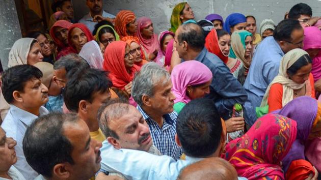 Family members of officer Shail Bala Sharma mourn after she was allegedly shot dead by a hotel owner in Kasauli town, where Sharma had yesterday gone to supervise the demolition of unauthorised construction, in Mandi on Wednesday.(PTI Photo)