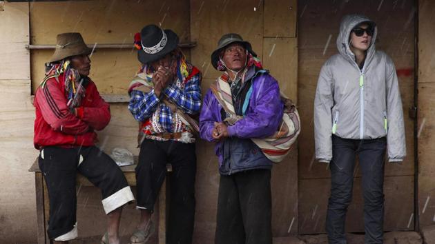 Andean muleteers and a tourist take cover from rain during a tour of the rainbow-colored mountain. “You see it in the pictures and you think it’s Photoshopped --but it’s real,” said Lukas Lynen, an 18-year-old tourist from Mexico. But on the other hand environmentalists fear the tourists could destroy this treasured landscape, which is already coveted by international mining companies. (Martin Mejia / AP) Andean muleteers and a tourist take cover from rain during a tour of the rainbow-colored mountain. “You see it in the pictures and you think it’s Photoshopped --but it’s real,” said Lukas Lynen, an 18-year-old tourist from Mexico. But on the other hand environmentalists fear the tourists could destroy this treasured landscape, which is already coveted by international mining companies. (Martin Mejia / AP)