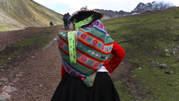 An Andean woman walks up to the mountain. Despite all the challenges, roughly 500 villagers have returned in the last couple of years to take up their ancestral trade of transporting goods across the Andes. The difference is that now they are hauling tourists on horseback. (Martin Mejia / AP) An Andean woman walks up to the mountain. Despite all the challenges, roughly 500 villagers have returned in the last couple of years to take up their ancestral trade of transporting goods across the Andes. The difference is that now they are hauling tourists on horseback. (Martin Mejia / AP)