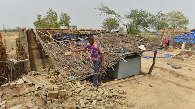 A man shows his thatched house damaged in Wednesday's massive storm, at Cheet village in Agra district on Friday.(PTI photo) A man shows his thatched house damaged in Wednesday's massive storm, at Cheet village in Agra district on Friday.(PTI photo)