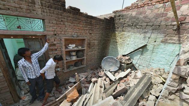 A man in Agra stands in his house that collapsed in the Wednesday’s powerful storm. Agra district bore the brunt of the storm that killed more than 100 people in north and west India.(PTI) A man in Agra stands in his house that collapsed in the Wednesday’s powerful storm. Agra district bore the brunt of the storm that killed more than 100 people in north and west India.(PTI)