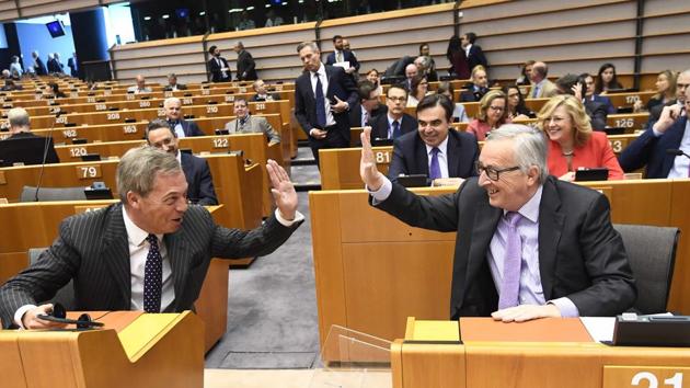 European Commission President Jean-Claude Juncker (R) and Brexit campaigner and member of the European Parliament Nigel Farage exchange a “high five”, at the start of the plenary session on the EU's next long-term budget, in the European Parliament in Brussels, Belgium. (Emmanuel Dunand / AFP) European Commission President Jean-Claude Juncker (R) and Brexit campaigner and member of the European Parliament Nigel Farage exchange a “high five”, at the start of the plenary session on the EU's next long-term budget, in the European Parliament in Brussels, Belgium. (Emmanuel Dunand / AFP)