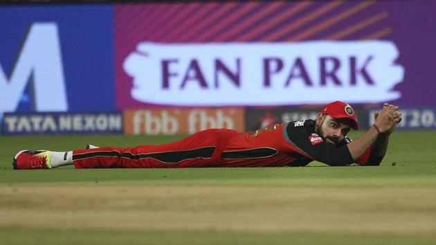 Royal Challengers Bangalore captain Virat Kohli falls after an unsuccessful fielding attempt to catch of Kolkata Knight Riders’ Sunil Narine during the VIVO IPL Twenty20 cricket match in Bangalore, Karnataka on April 29, 2018. (Aijaz Rahi / AP) Royal Challengers Bangalore captain Virat Kohli falls after an unsuccessful fielding attempt to catch of Kolkata Knight Riders’ Sunil Narine during the VIVO IPL Twenty20 cricket match in Bangalore, Karnataka on April 29, 2018. (Aijaz Rahi / AP)