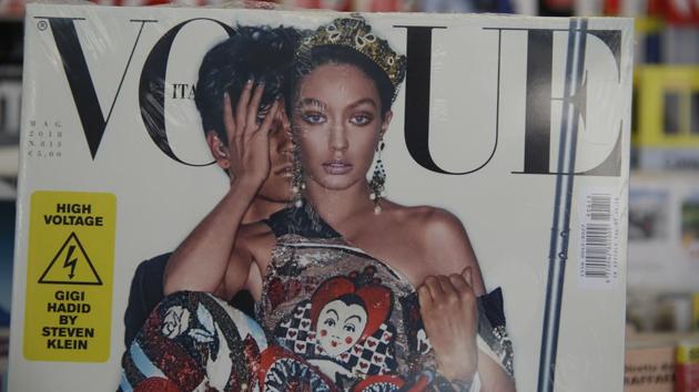 The cover shot by Steven Klein shows the normally blonde Hadid with dark hair and heavily bronzed skin, wearing matching a Dolce & Gabbana sequined legging ensemble with matching tiara.(AP) The cover shot by Steven Klein shows the normally blonde Hadid with dark hair and heavily bronzed skin, wearing matching a Dolce & Gabbana sequined legging ensemble with matching tiara.(AP)