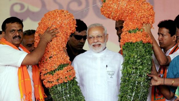 Prime Minister Narendra Modi being garlanded during a public rally ahead of the Karnataka assembly election in Tumakuru on Saturday. (PTI) Prime Minister Narendra Modi being garlanded during a public rally ahead of the Karnataka assembly election in Tumakuru on Saturday. (PTI)