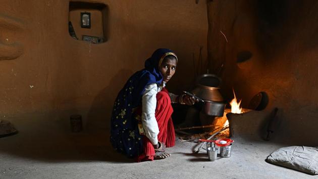 A woman cooks in her home in Kraska village. While a few villages have opted for the government’s relocation package of ₹10 lakh to every adult member of the family, resulting in the creation of sanctuaries for female tigers ST-3 and ST-5 and their progeny around Bhagani village, the majority have stayed on stalling the efforts. (Anindito Mukherjee / Bloomberg)