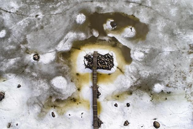 A wooden jetty is surrounded by melting sea ice in the islands of Merenkurkku Archipelago, near Vaasa, Finland. Spring has started to melt a way through the giant frozen expanse of this archipelago in western Finland, as cracks in the ice turn into rust-coloured pools around wooden jetties in a sign of the coming summer. (Olivier Morin / AFP) A wooden jetty is surrounded by melting sea ice in the islands of Merenkurkku Archipelago, near Vaasa, Finland. Spring has started to melt a way through the giant frozen expanse of this archipelago in western Finland, as cracks in the ice turn into rust-coloured pools around wooden jetties in a sign of the coming summer. (Olivier Morin / AFP)