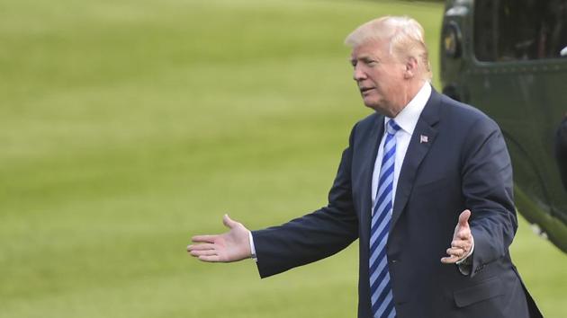 US President Donald Trump gestures after arriving on Marine One at the White House in Washington, DC, on May 4, 2018. (AFP) US President Donald Trump gestures after arriving on Marine One at the White House in Washington, DC, on May 4, 2018. (AFP)
