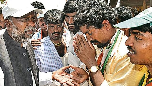 Social welfare minister H Anjaneya (left) during a campaign in Holalkere, Karnataka, on Friday.(Arijit Sen/HT) Social welfare minister H Anjaneya (left) during a campaign in Holalkere, Karnataka, on Friday.(Arijit Sen/HT)
