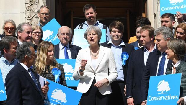 Britain's Prime Minister Theresa May (C) flanked by supporters poses outside Wandsworth Town hall in London after the Conservative party retained control of the council following local elections on May 4, 2018.(AFP) Britain's Prime Minister Theresa May (C) flanked by supporters poses outside Wandsworth Town hall in London after the Conservative party retained control of the council following local elections on May 4, 2018.(AFP)