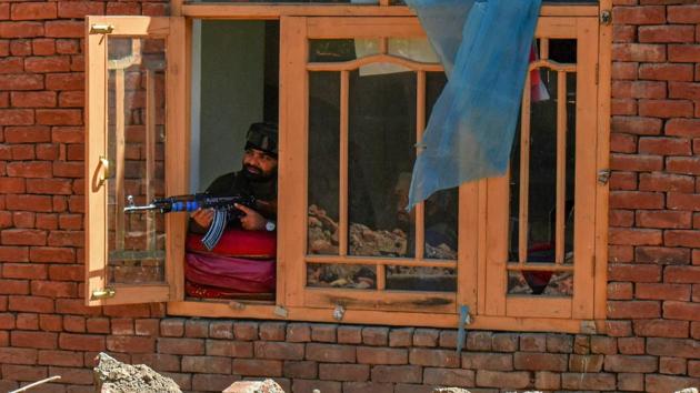 A security person stands guard during an encounter between security forces and militants took place at Drabgam in South Kashmir.(PTI File Photo)