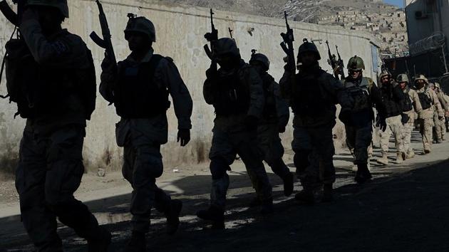 In this file photo taken on January 21, 2013, Afghan commandos walk down a road near the Kabul police headquarters building.(AFP)