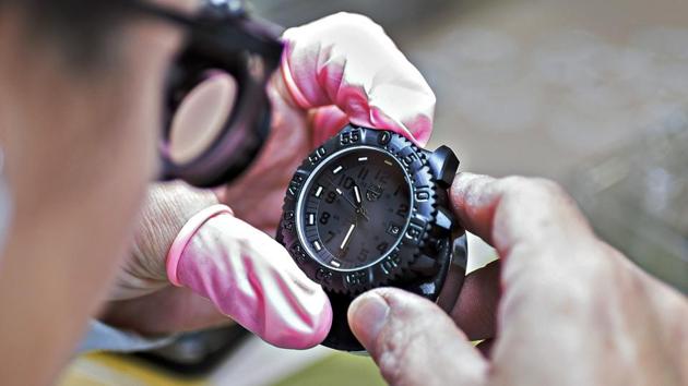 A watchmaker examines his creation.(Bloomberg)