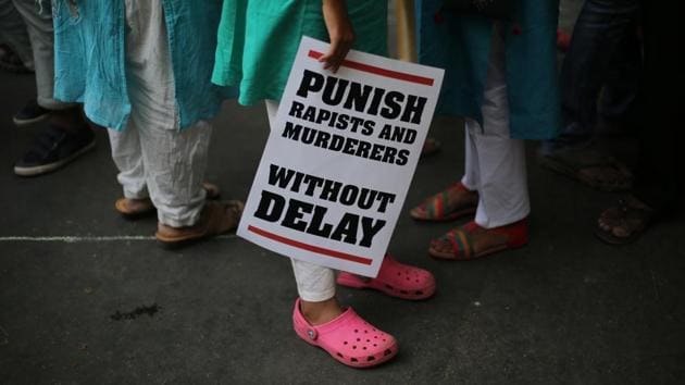 In this April 15 file photo, a protestor stands with a placard during a protest against rape, in New Delhi.(AP)